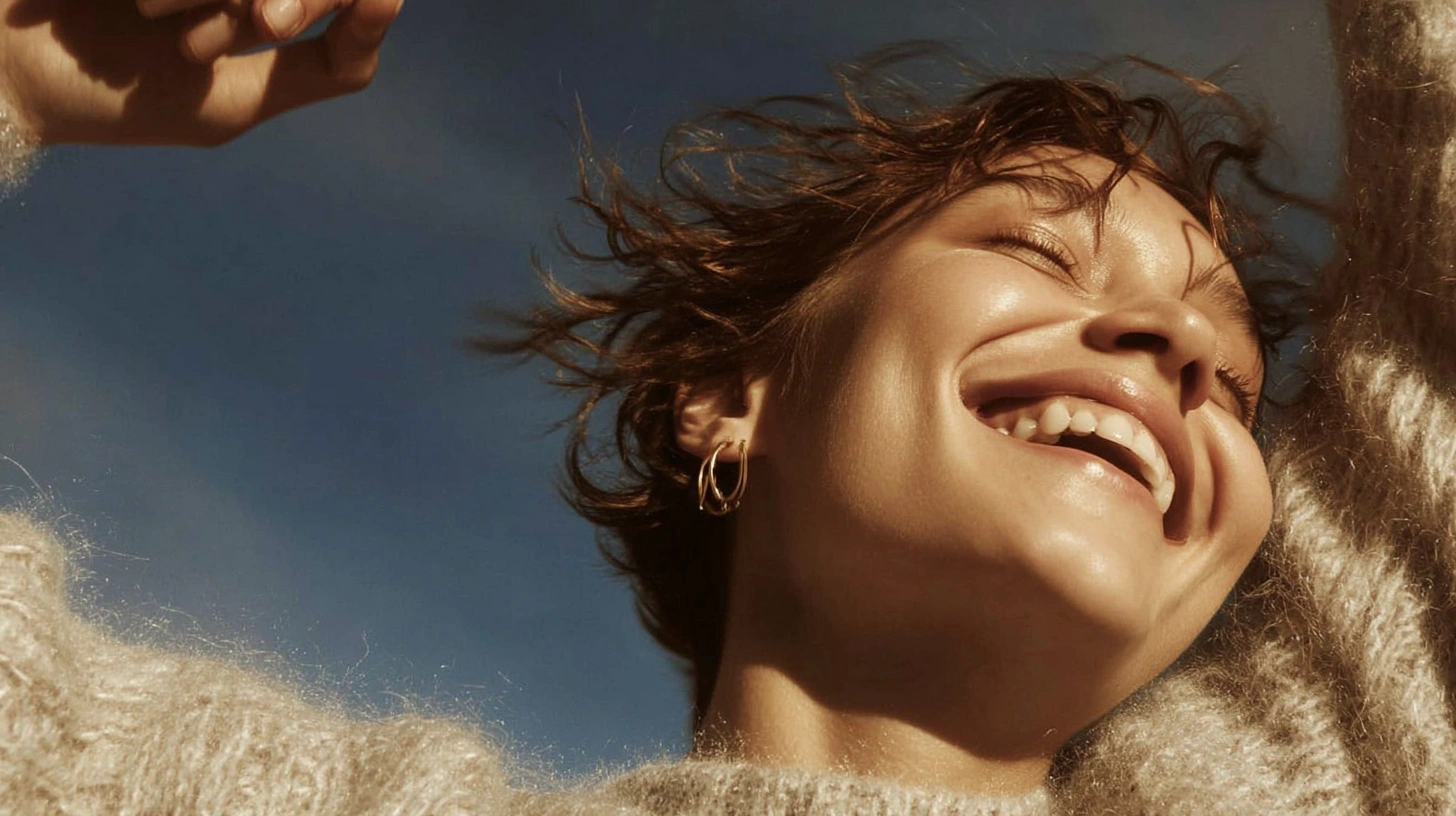 A joyful person enjoying a sunlit moment with their eyes closed